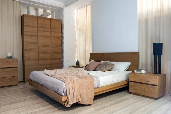 Contemporary bedroom with warm wooden bed frame and matching wardrobe